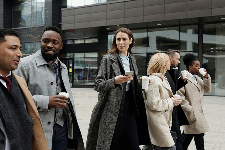 People walking with coffee conversations in English